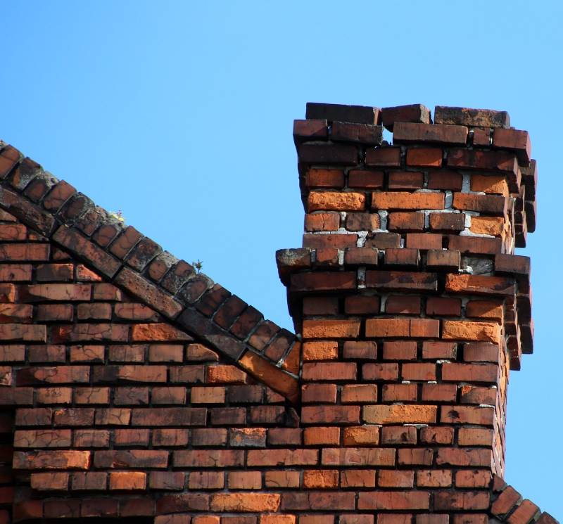 Damaged chimney on an Hingham home showing cracks and missing mortar